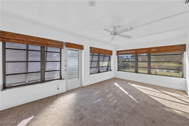 unfurnished sunroom featuring ceiling fan