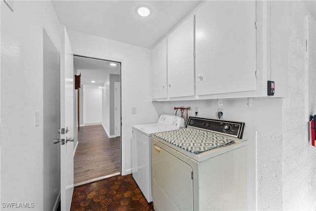 washroom featuring dark hardwood / wood-style flooring, cabinets, and independent washer and dryer