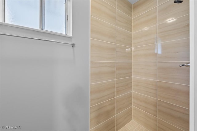 bathroom with tiled shower