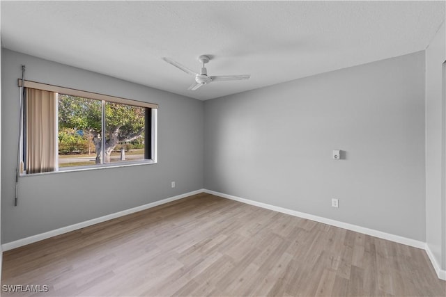 unfurnished room featuring a textured ceiling, light hardwood / wood-style flooring, and ceiling fan