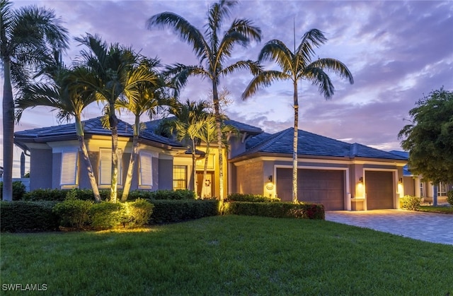 view of front of home with a lawn and a garage