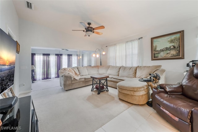 tiled living room featuring ceiling fan, a wealth of natural light, and vaulted ceiling