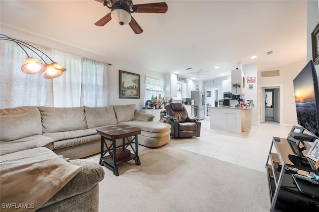 living room featuring ceiling fan and light tile patterned flooring