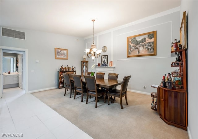 dining room with light carpet and a chandelier