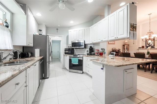 kitchen with sink, ceiling fan, decorative light fixtures, white cabinetry, and stainless steel appliances