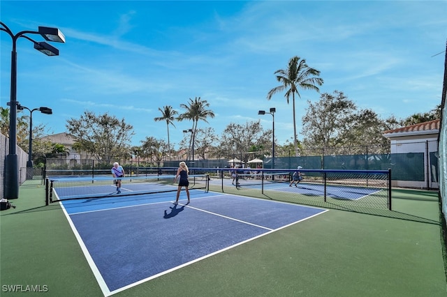 view of tennis court featuring basketball court