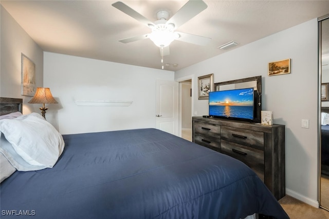 bedroom featuring ceiling fan and light carpet