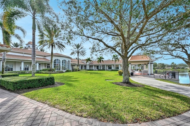 surrounding community featuring a water view and a yard