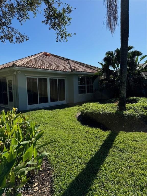 rear view of property with a yard