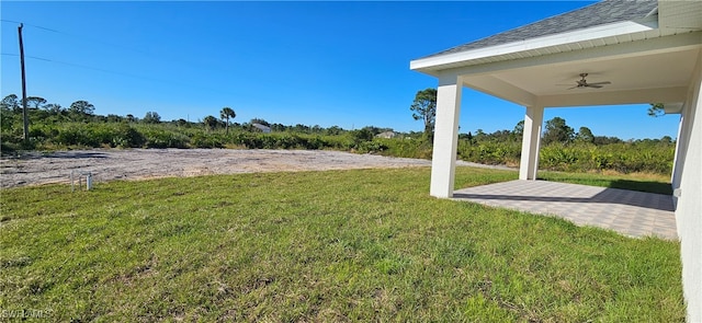 view of yard with a patio area and ceiling fan