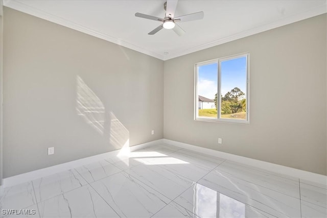 unfurnished room with ornamental molding, marble finish floor, ceiling fan, and baseboards