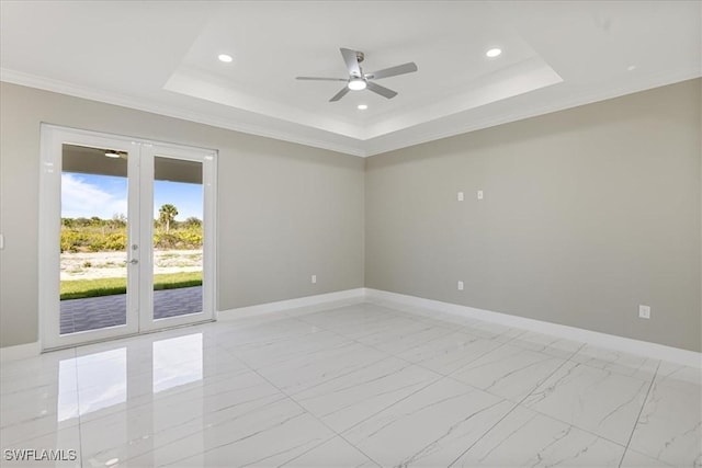 spare room featuring a tray ceiling, french doors, and baseboards