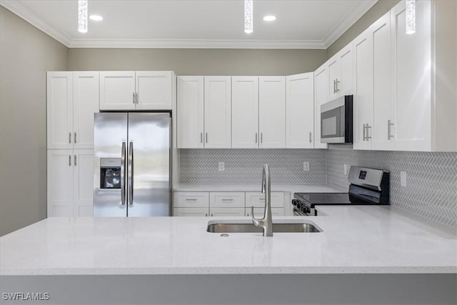 kitchen with crown molding, backsplash, appliances with stainless steel finishes, white cabinets, and a sink