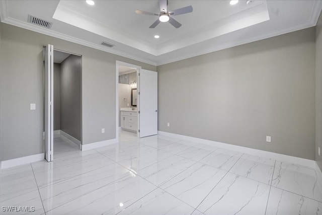 unfurnished room with crown molding, a tray ceiling, visible vents, and baseboards