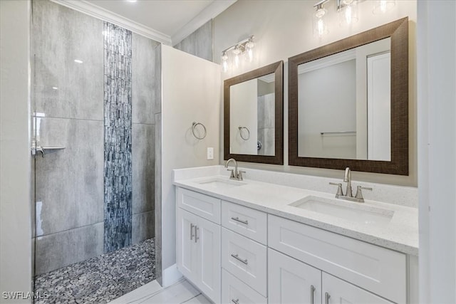 full bathroom with double vanity, ornamental molding, walk in shower, and a sink