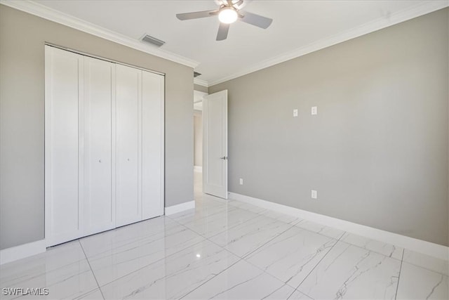 unfurnished bedroom featuring marble finish floor, a closet, visible vents, ornamental molding, and baseboards