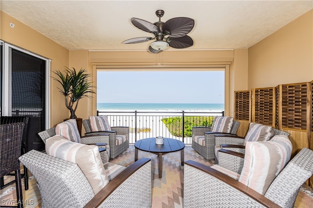 balcony with ceiling fan, outdoor lounge area, and a water view