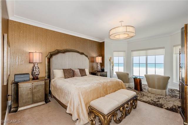 bedroom with wooden walls, crown molding, light carpet, and a water view