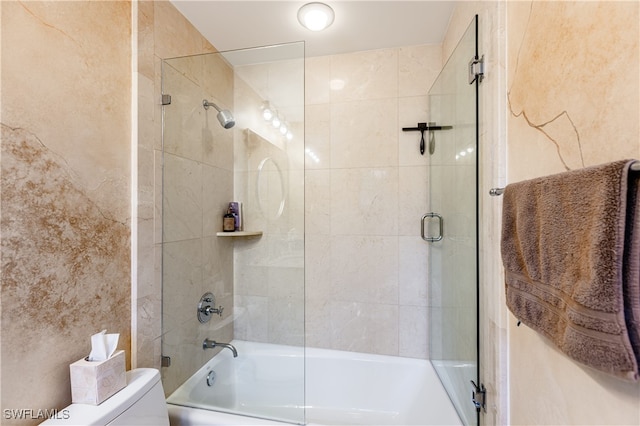 bathroom with shower / bath combination with glass door and toilet