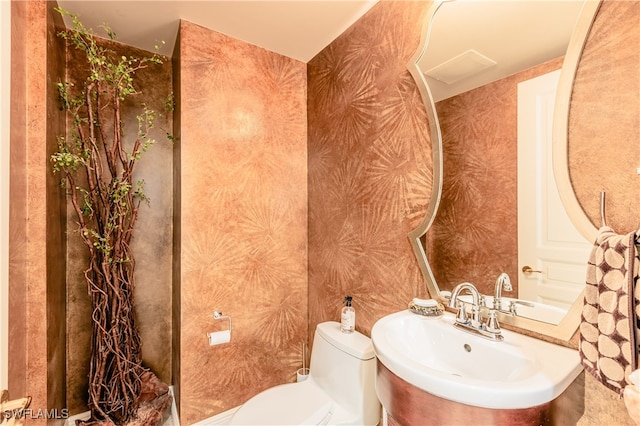 bathroom featuring sink and toilet