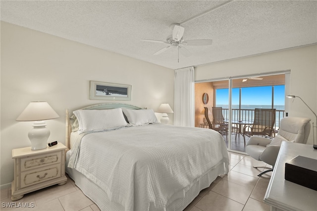 tiled bedroom featuring access to exterior, ceiling fan, and a textured ceiling