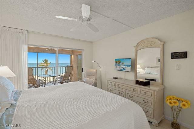 bedroom with ceiling fan, access to exterior, and a textured ceiling