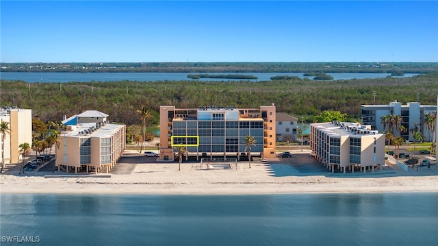 birds eye view of property with a beach view and a water view