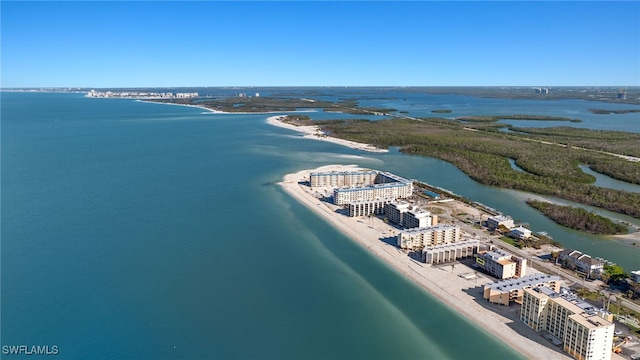 birds eye view of property with a water view and a view of the beach