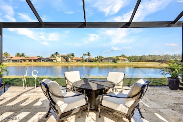 view of patio / terrace with a water view and glass enclosure