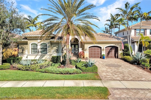 mediterranean / spanish home with a garage