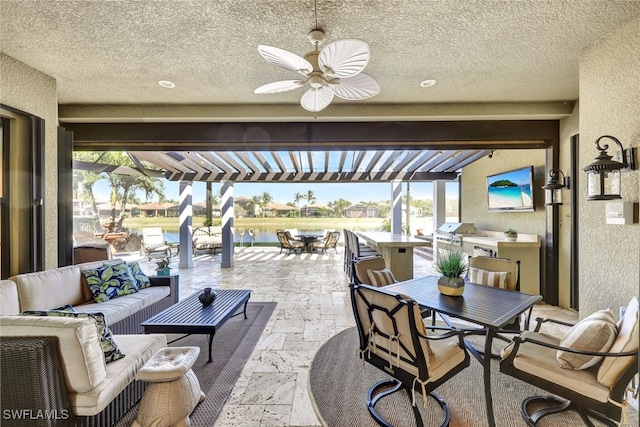 view of patio with an outdoor kitchen, a grill, an outdoor hangout area, and a pergola