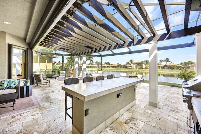 view of patio featuring a pergola, a water view, and an outdoor bar