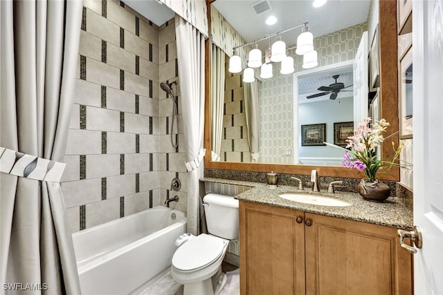 full bathroom with ceiling fan, vanity, toilet, and shower / tub combo