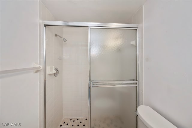 bathroom featuring toilet and walk in shower