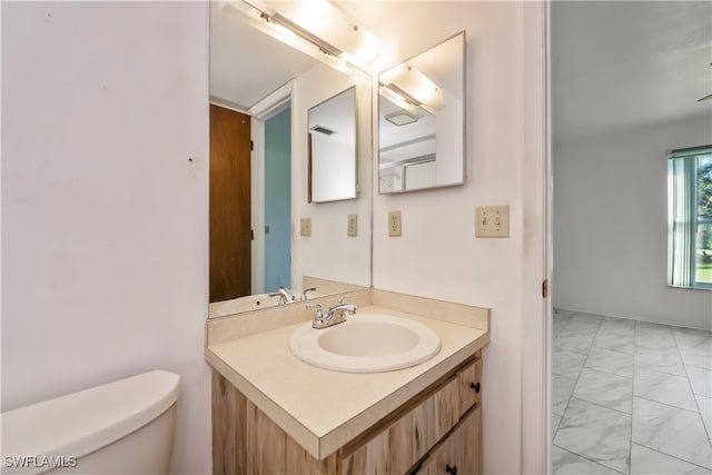 bathroom featuring vanity and toilet