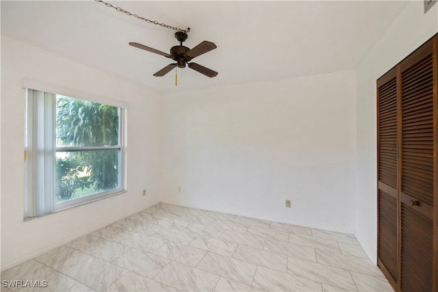 spare room with ceiling fan