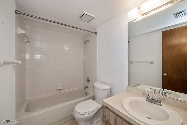 full bathroom with tile patterned flooring, tiled shower / bath combo, toilet, and vanity