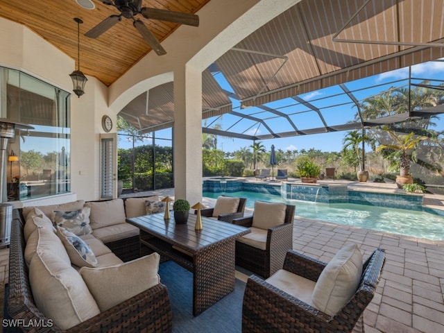 view of patio with glass enclosure, pool water feature, ceiling fan, and an outdoor hangout area