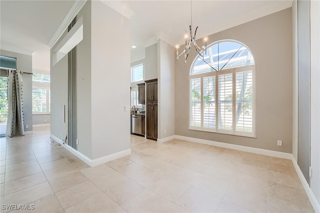 empty room featuring a chandelier and light tile patterned floors