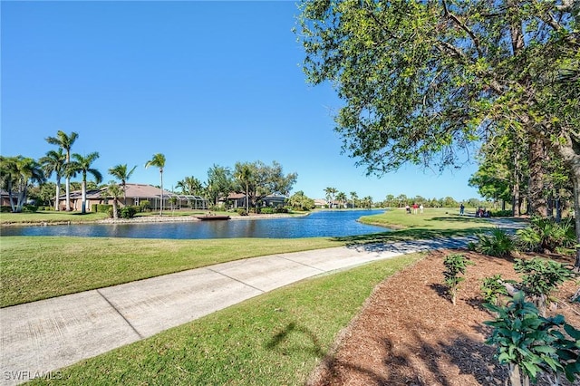 surrounding community featuring a yard and a water view