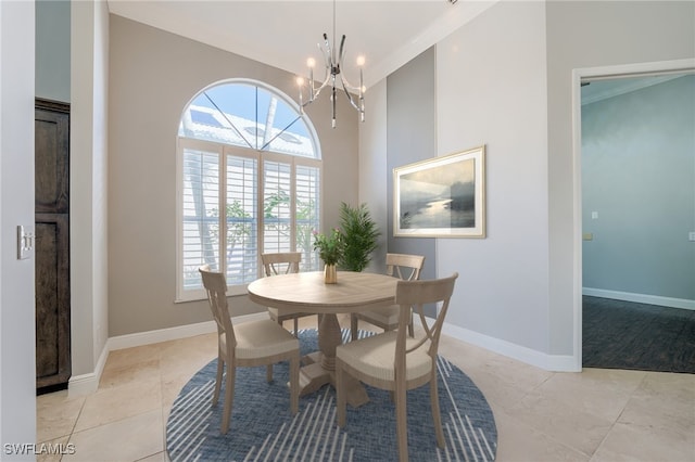 dining space featuring crown molding, light tile patterned floors, and a notable chandelier