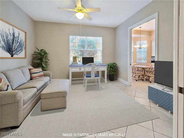 living room featuring ceiling fan with notable chandelier and light tile patterned floors