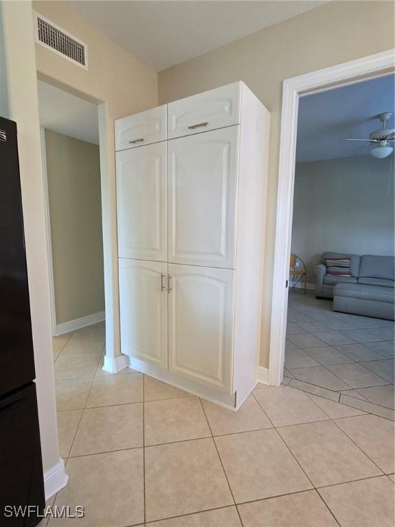 hallway featuring light tile patterned flooring