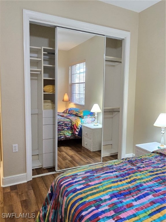 bedroom featuring a closet and dark wood-type flooring