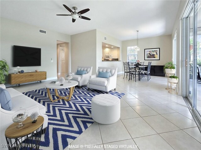 living room featuring light tile patterned floors and ceiling fan