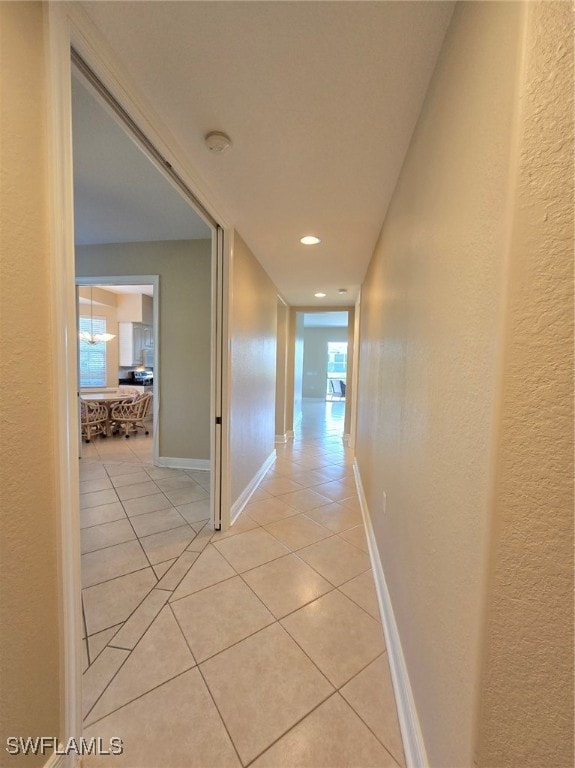 hall with light tile patterned floors