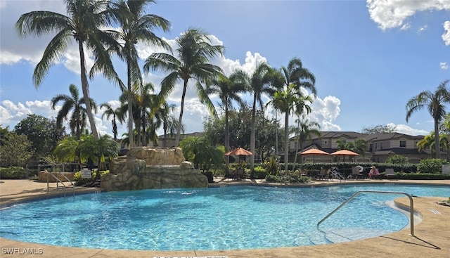 view of swimming pool with pool water feature