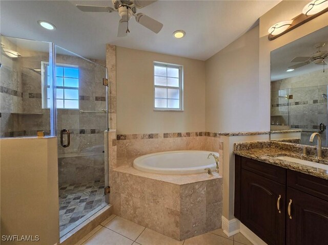 bathroom with shower with separate bathtub, tile patterned floors, ceiling fan, and vanity