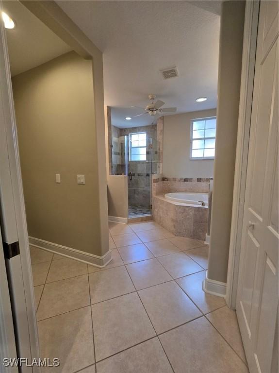 bathroom with tile patterned floors, ceiling fan, and separate shower and tub