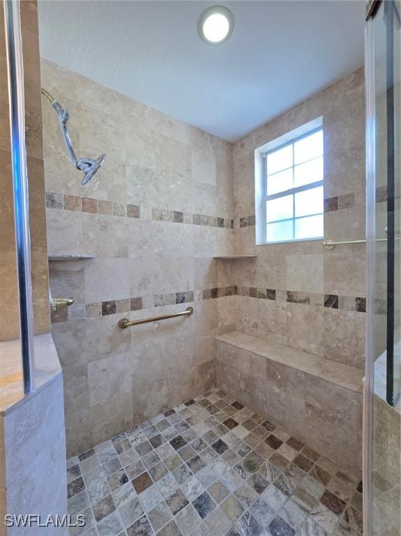 bathroom featuring tiled shower